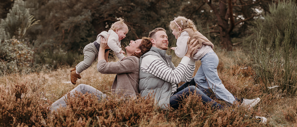 Spontane foto van gezin van vier op een gezinsfotoshoot opbuitenlocatie