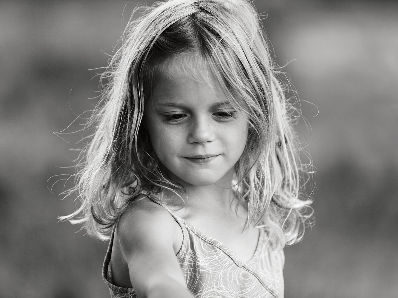 zwartwit foto van lief meisje tijdens een gezinsfotoshoot buiten